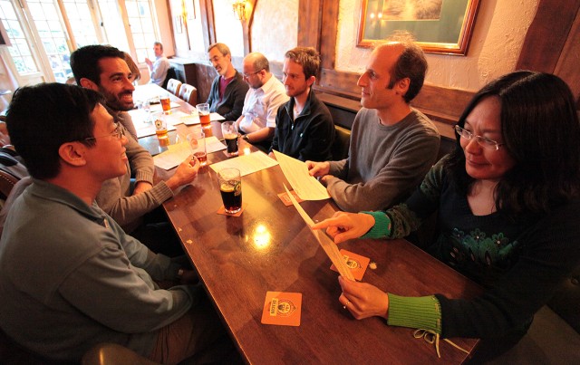 Hairer (second from right); his wife, Xue-Mei Li (far right); and several colleagues from the University of Warwick gathered at the Virgins and Castle gastropub in Kenilworth.