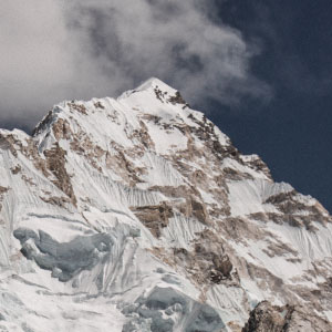 Climbing up the side of a high mountain peak.