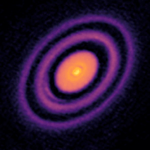 An array of images of protoplanetary disks with bright suns at the centers surrounded by rings, arcs, filaments and spirals.]