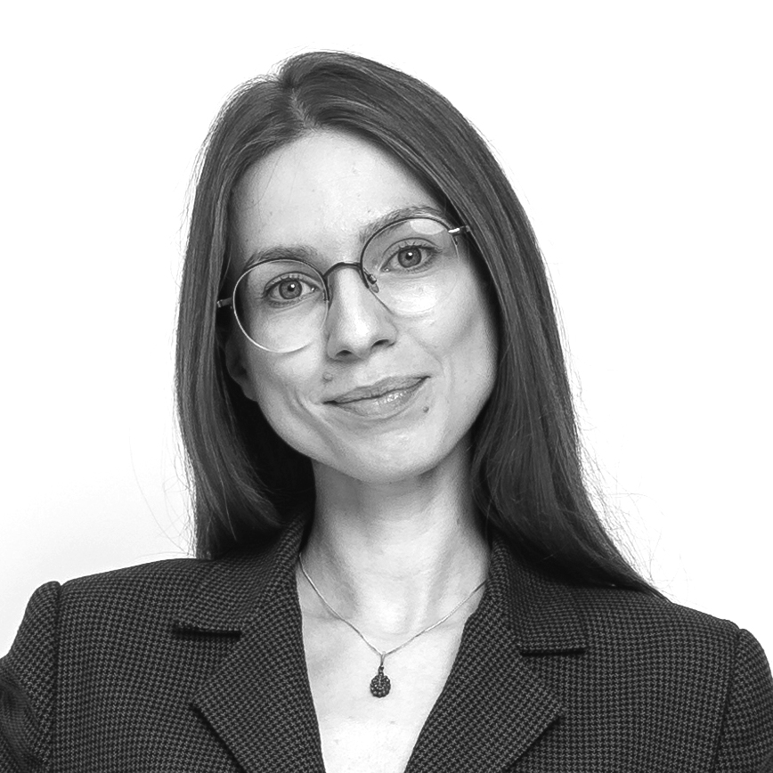 A woman with glasses in front of a blank background