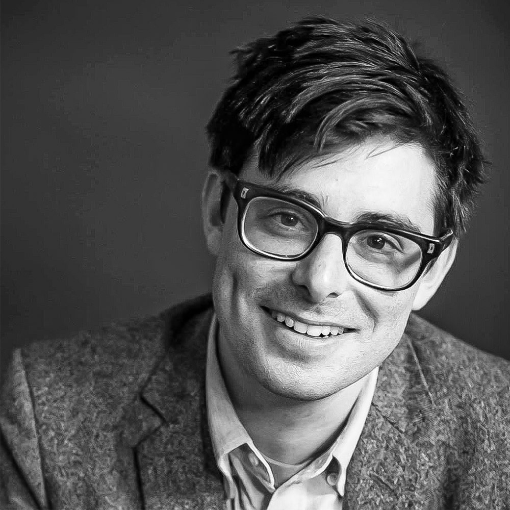 A smiling man with glasses
