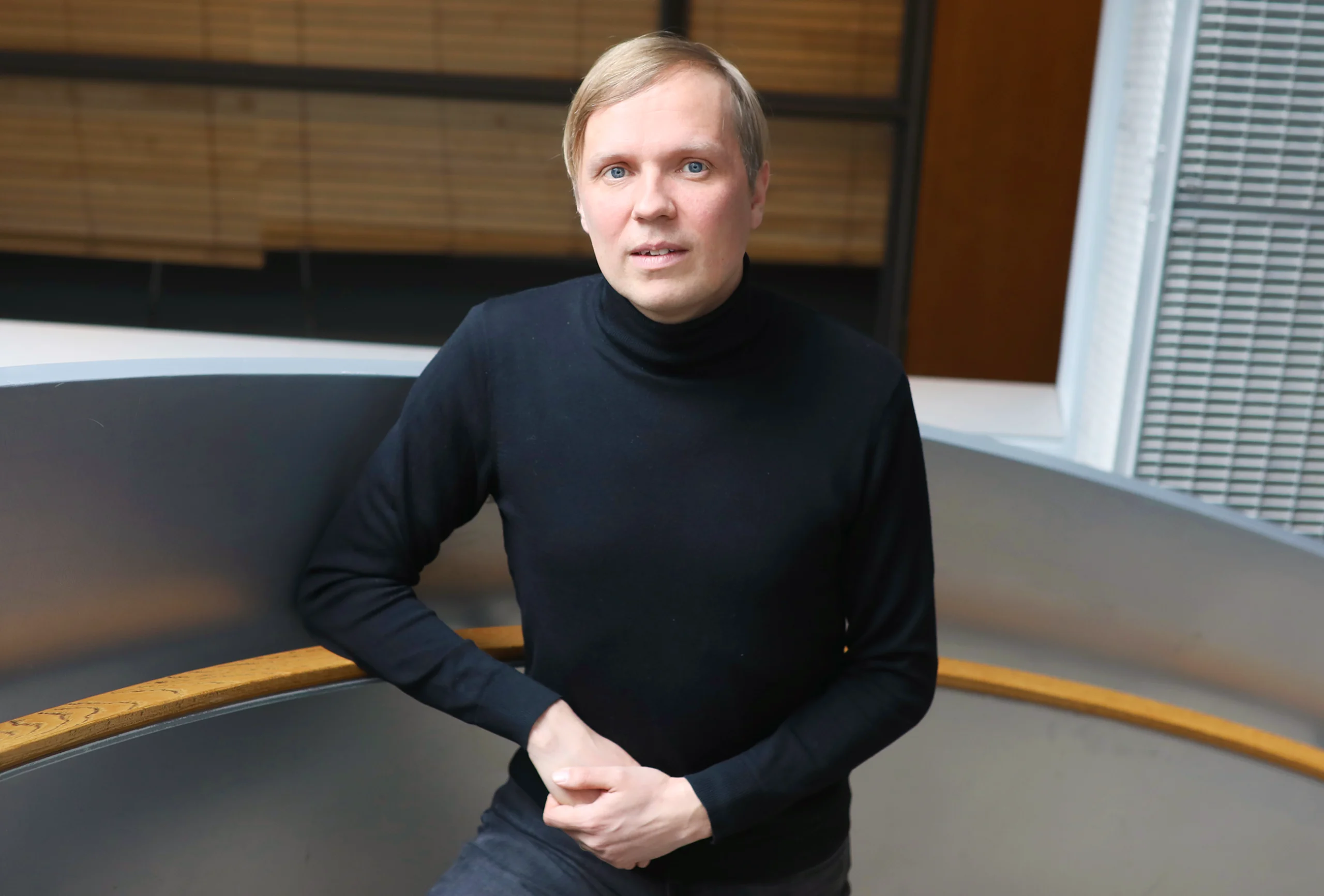 Man in a black turtleneck.