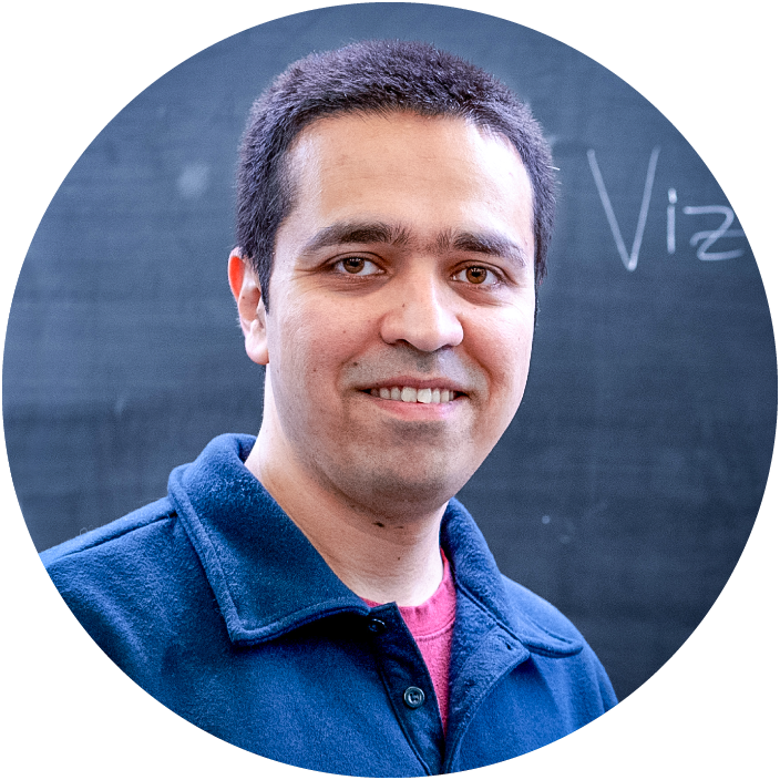 Sepehr Assadi in a blue sweater stands in front of a chalkboard explaining Vizing’s theorem.