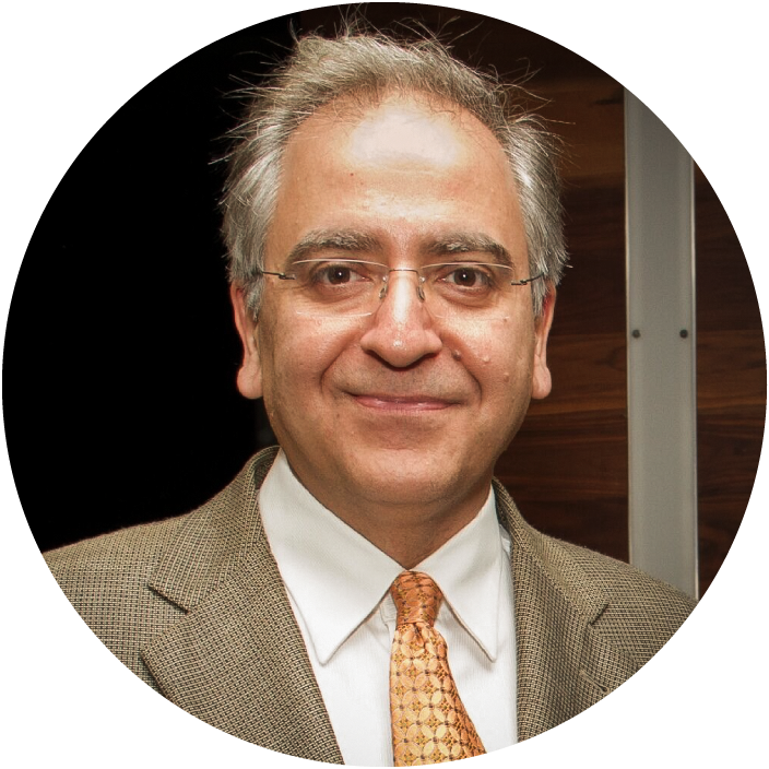 A bespectacled man wearing a suit
