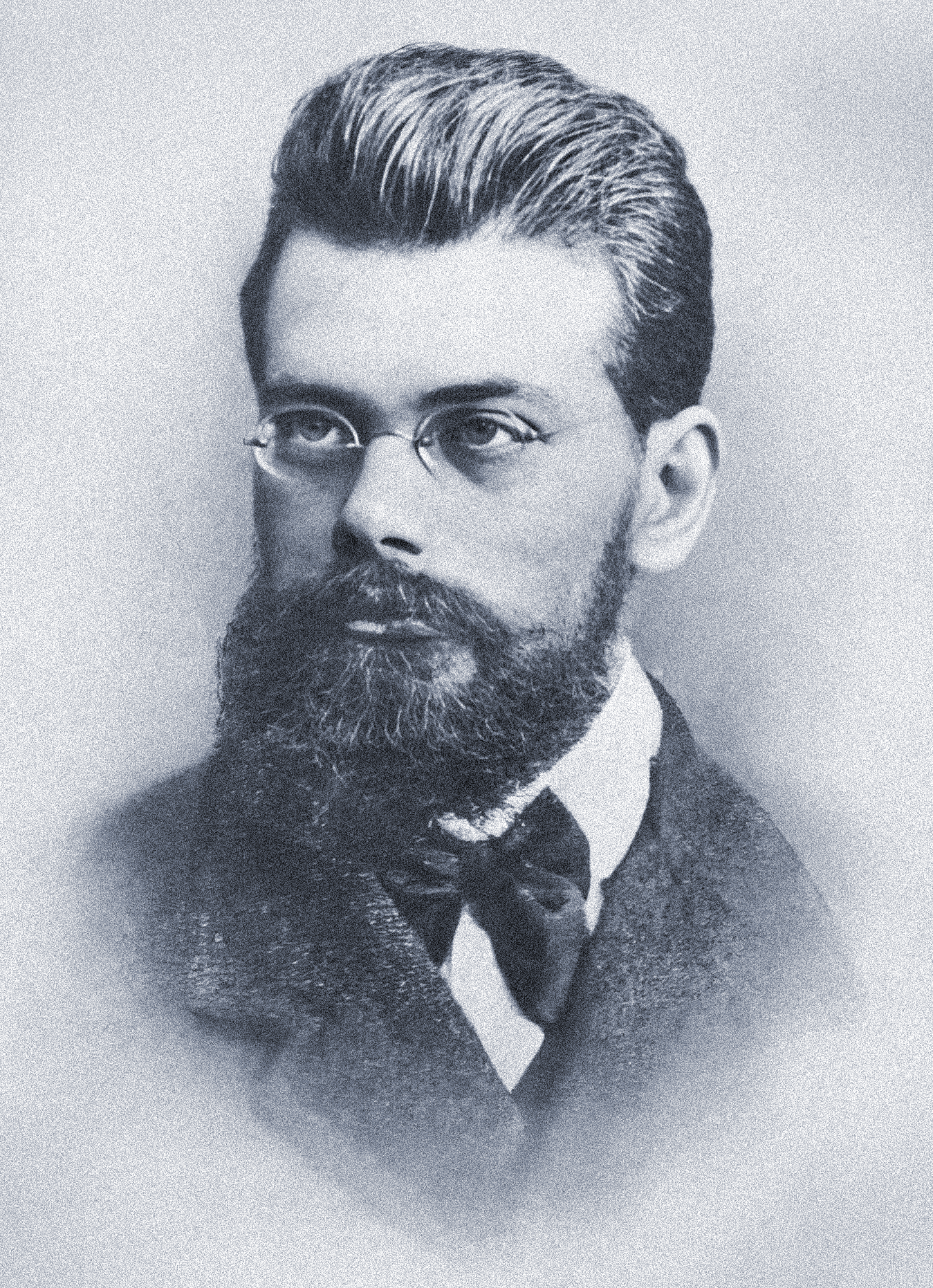 A bespectacled man in a suit