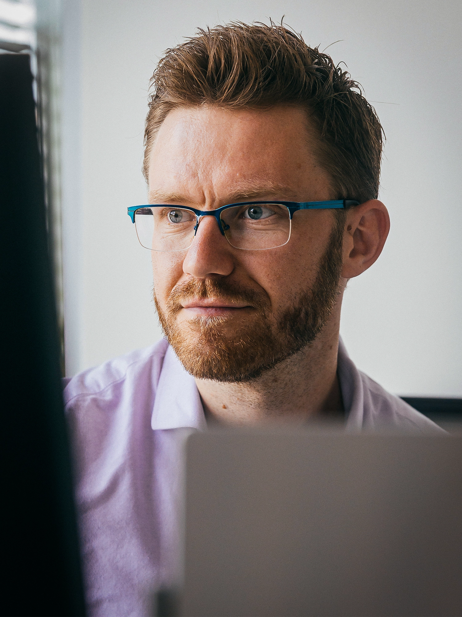 Martin Schimpf looks at a screen in front of a white wall