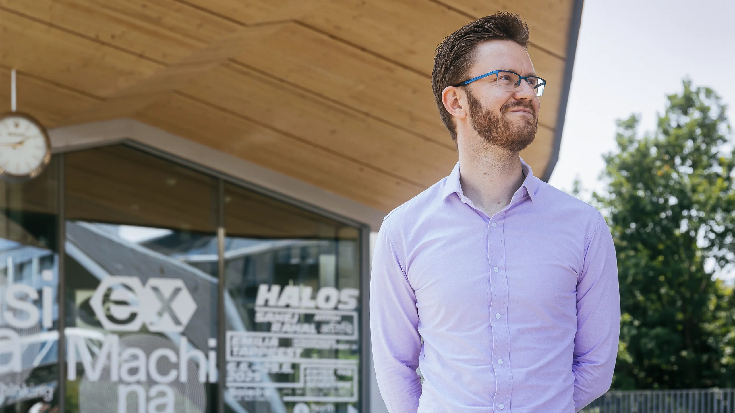 Martin Schrimpf in a purple shirt with a wooden structure in the background
