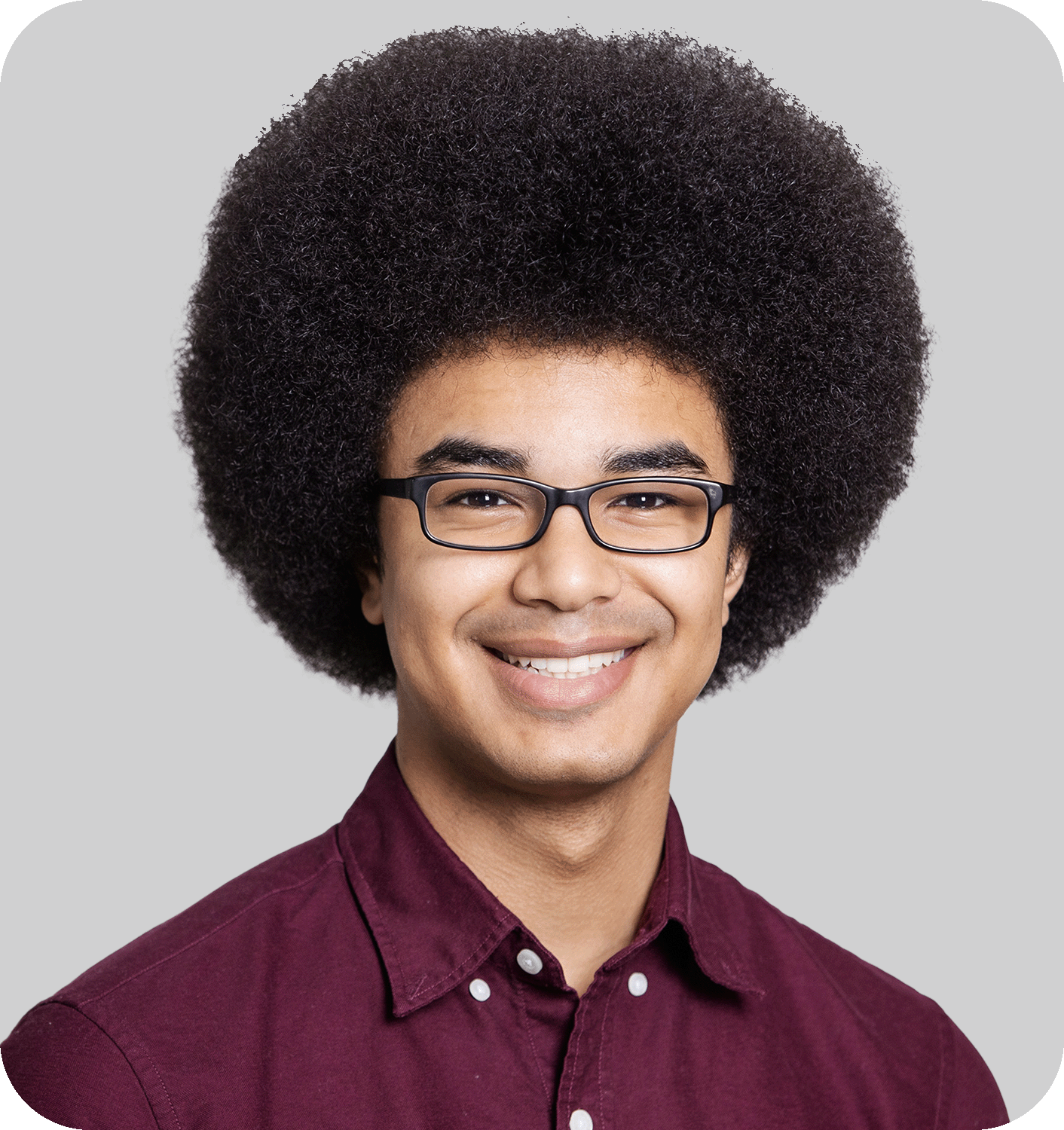 A smiling man with an afro and glasses