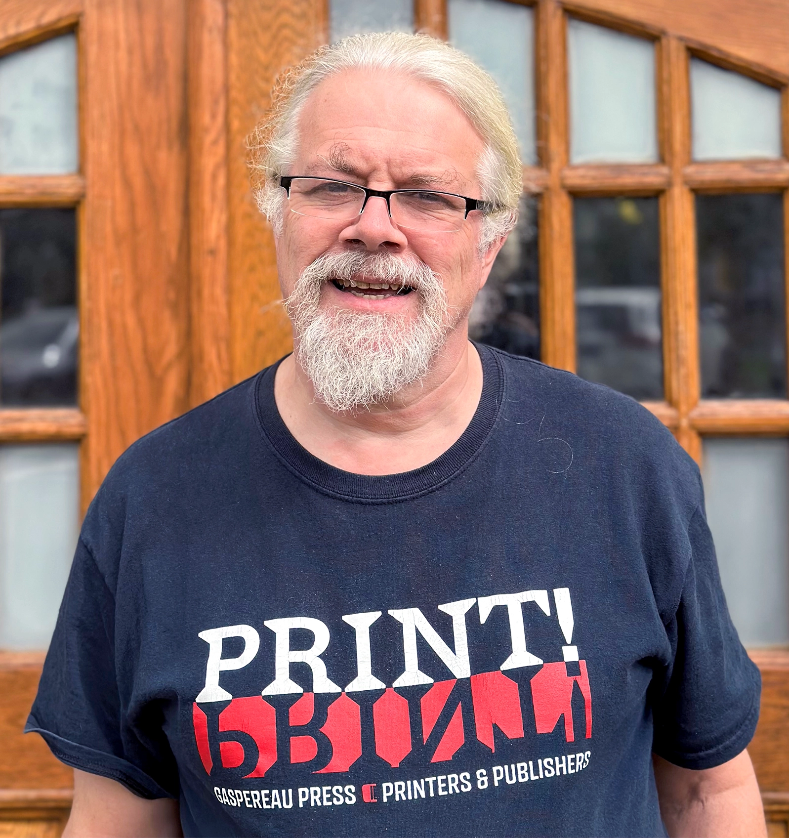 A man in a T-shirt standing outside.