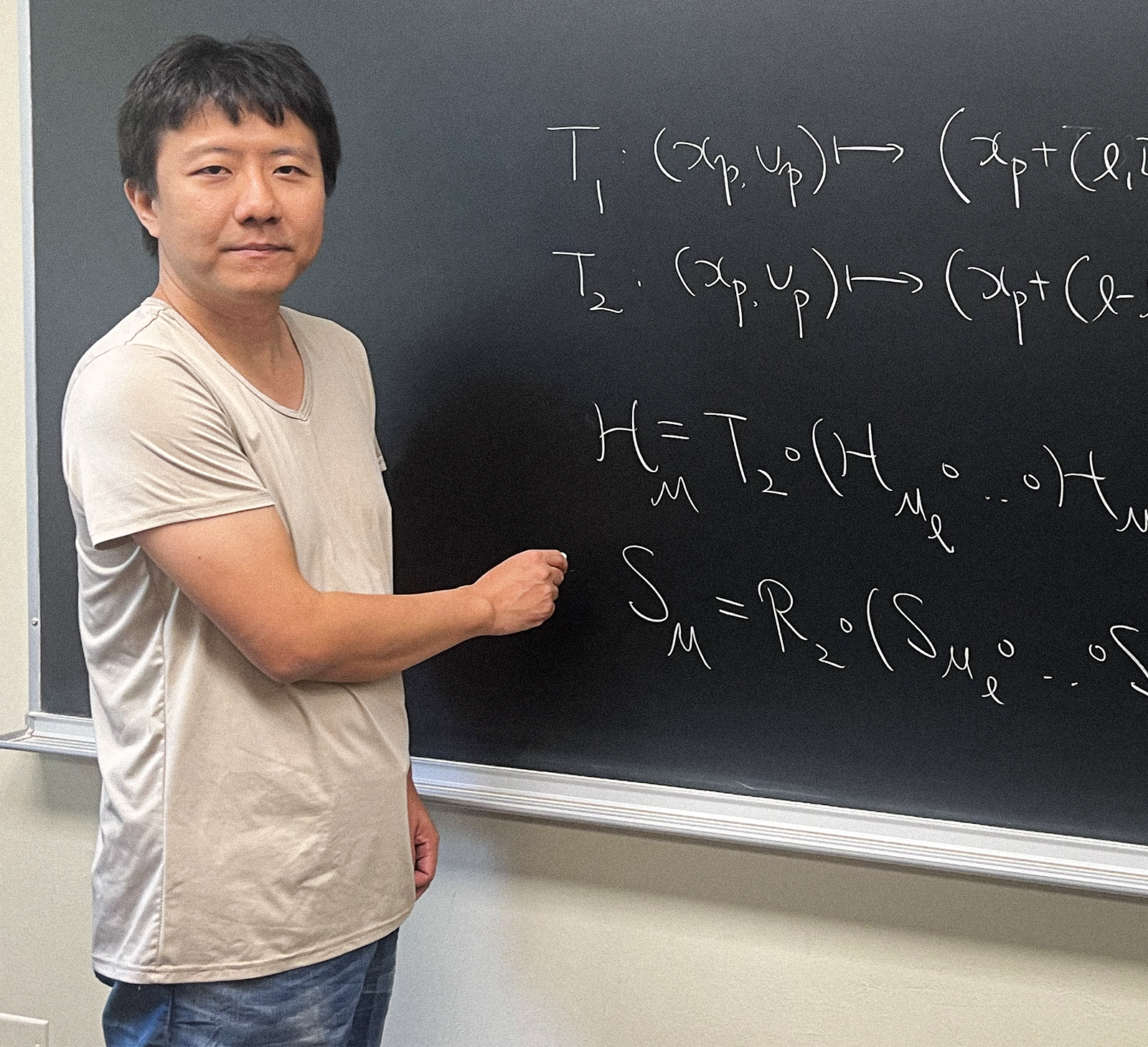 A man standing by a chalkboard