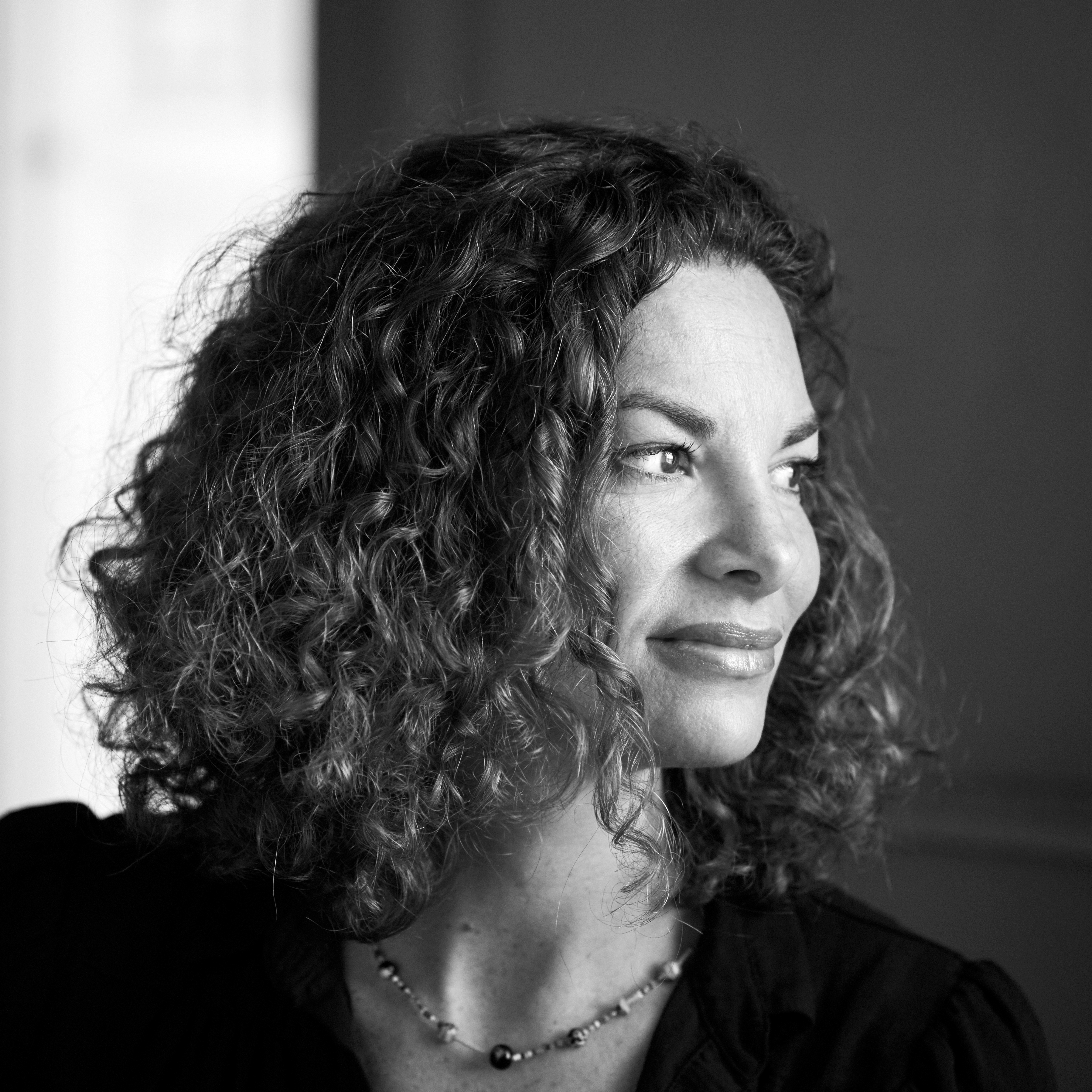 A smiling woman with curly hair