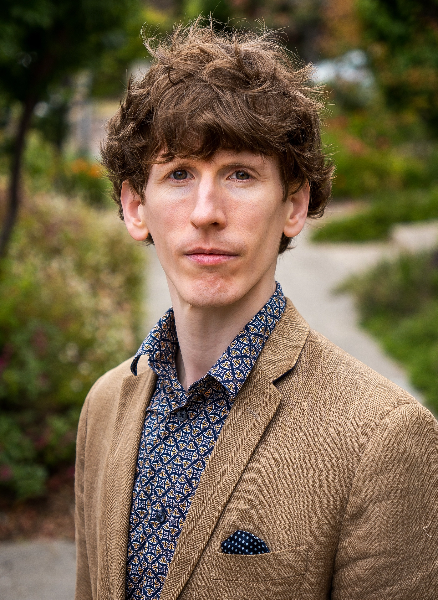a man with brown hair in a brown sport coat