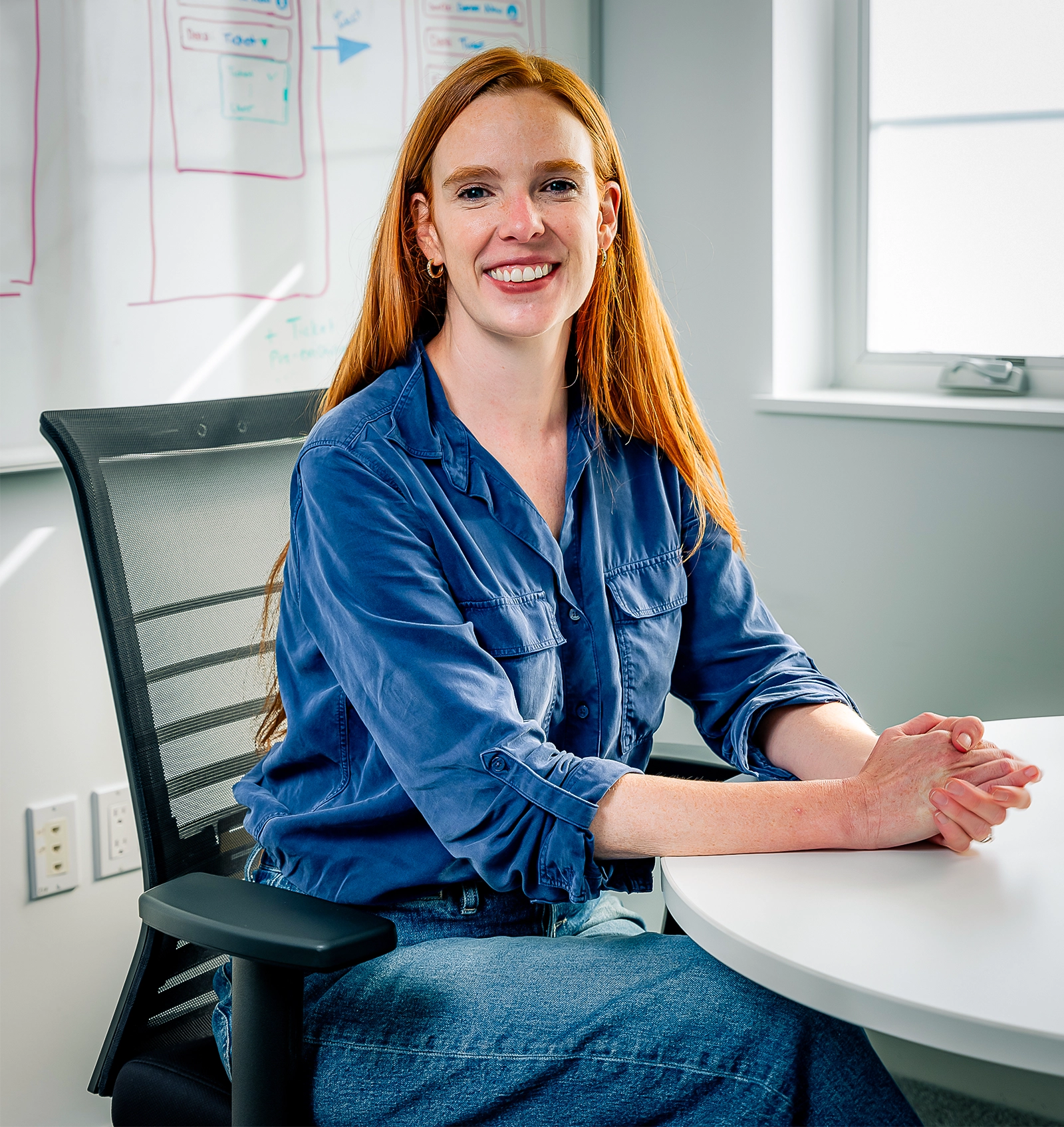 a smiling woman with red hair