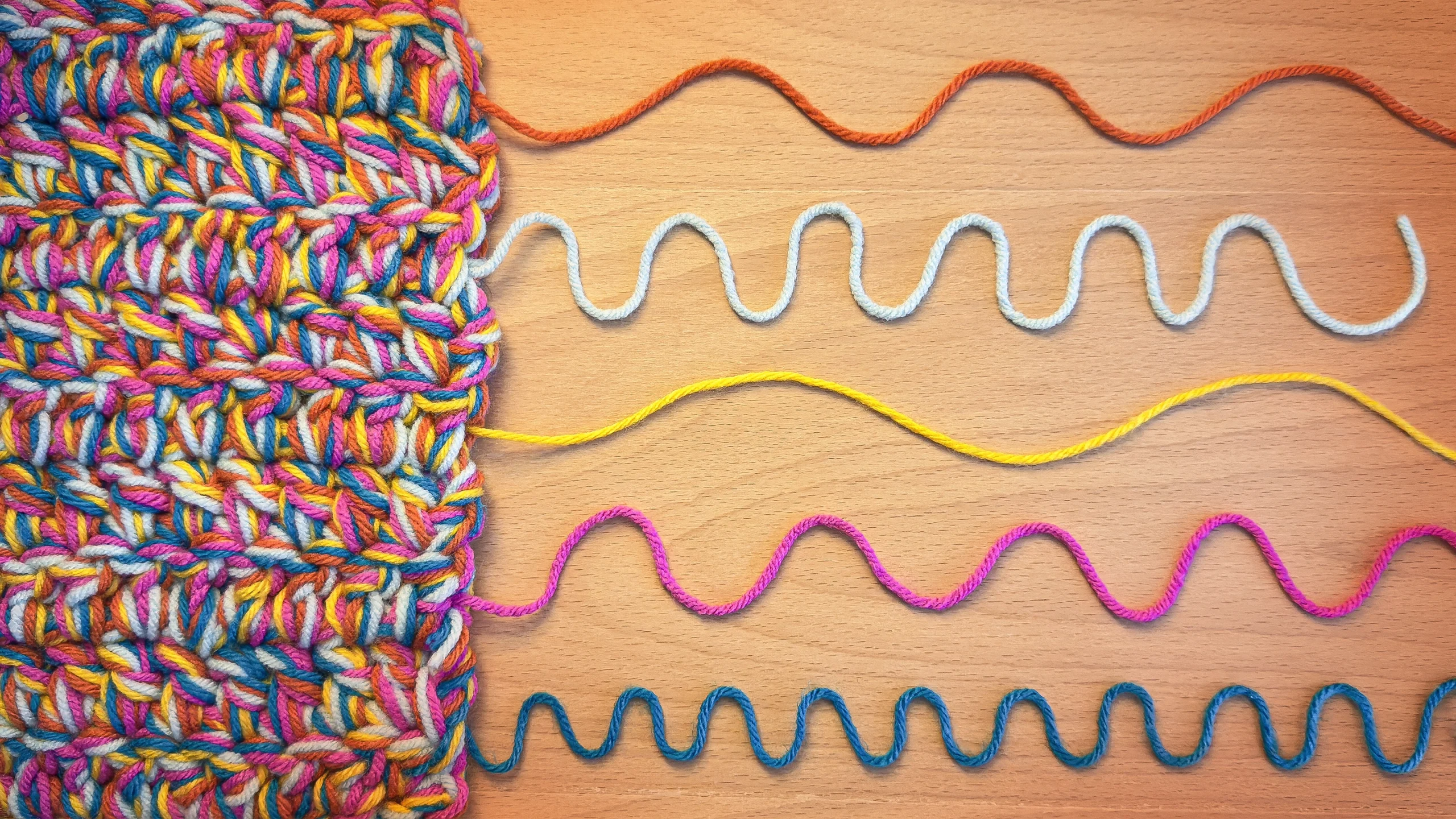 A textile with individual wavelike pieces of yarn emerging from it.