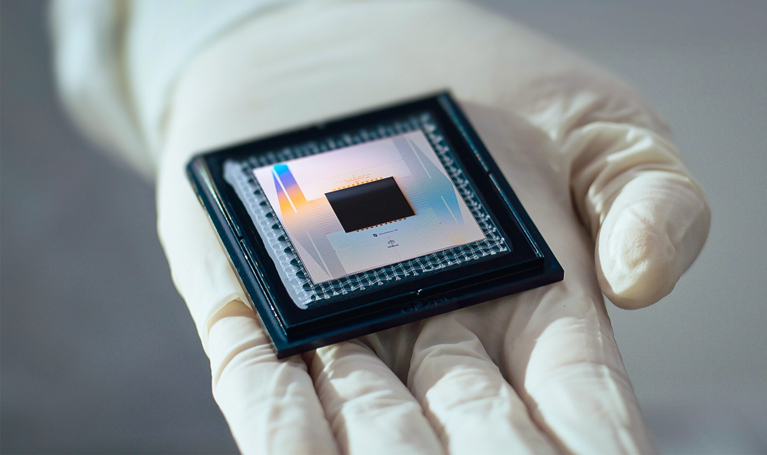 A small square electronic device that says “Google Quantum AI” on it.