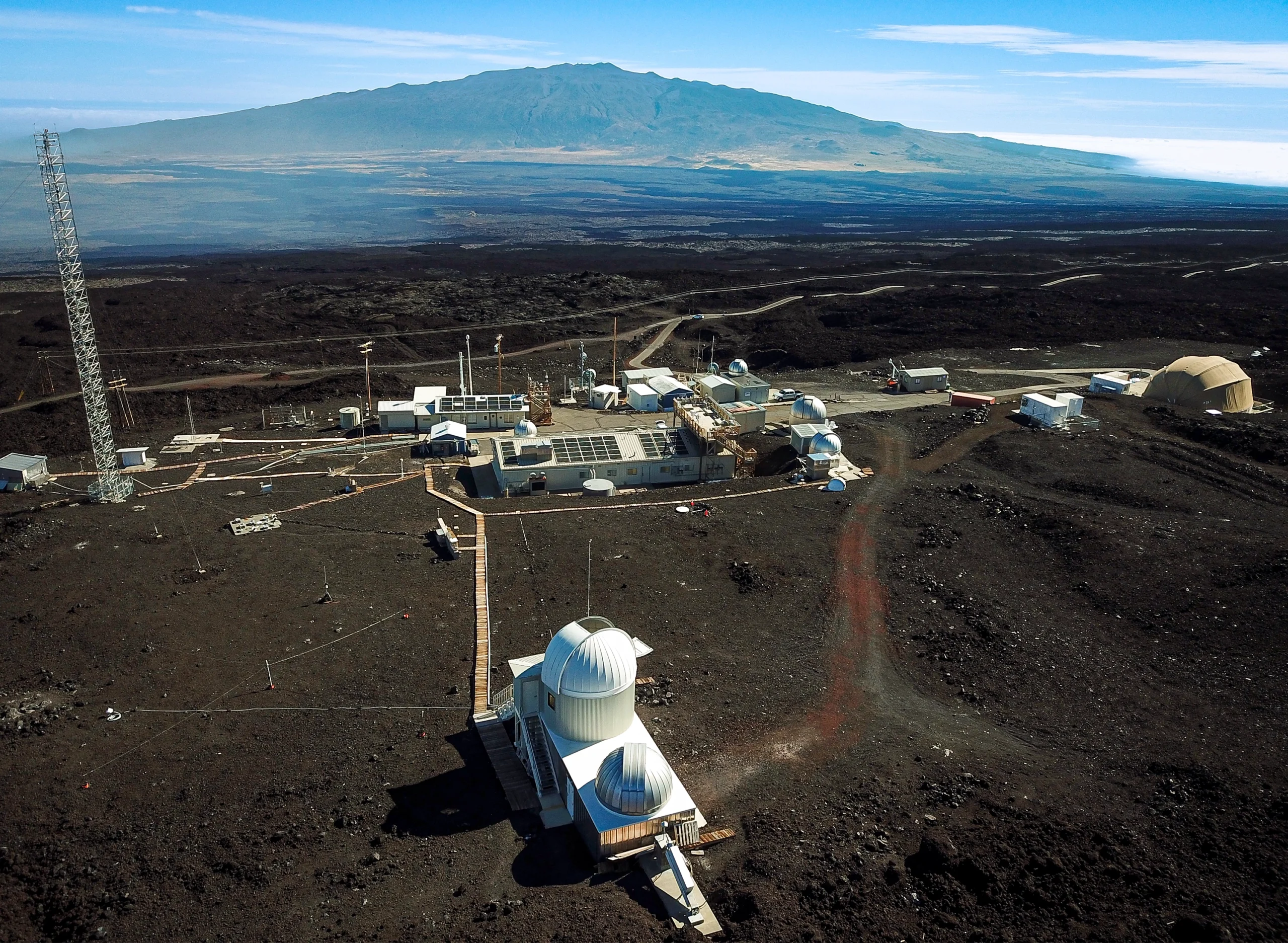 A cluster of white buildings sits on the Mauna Loa volcano.