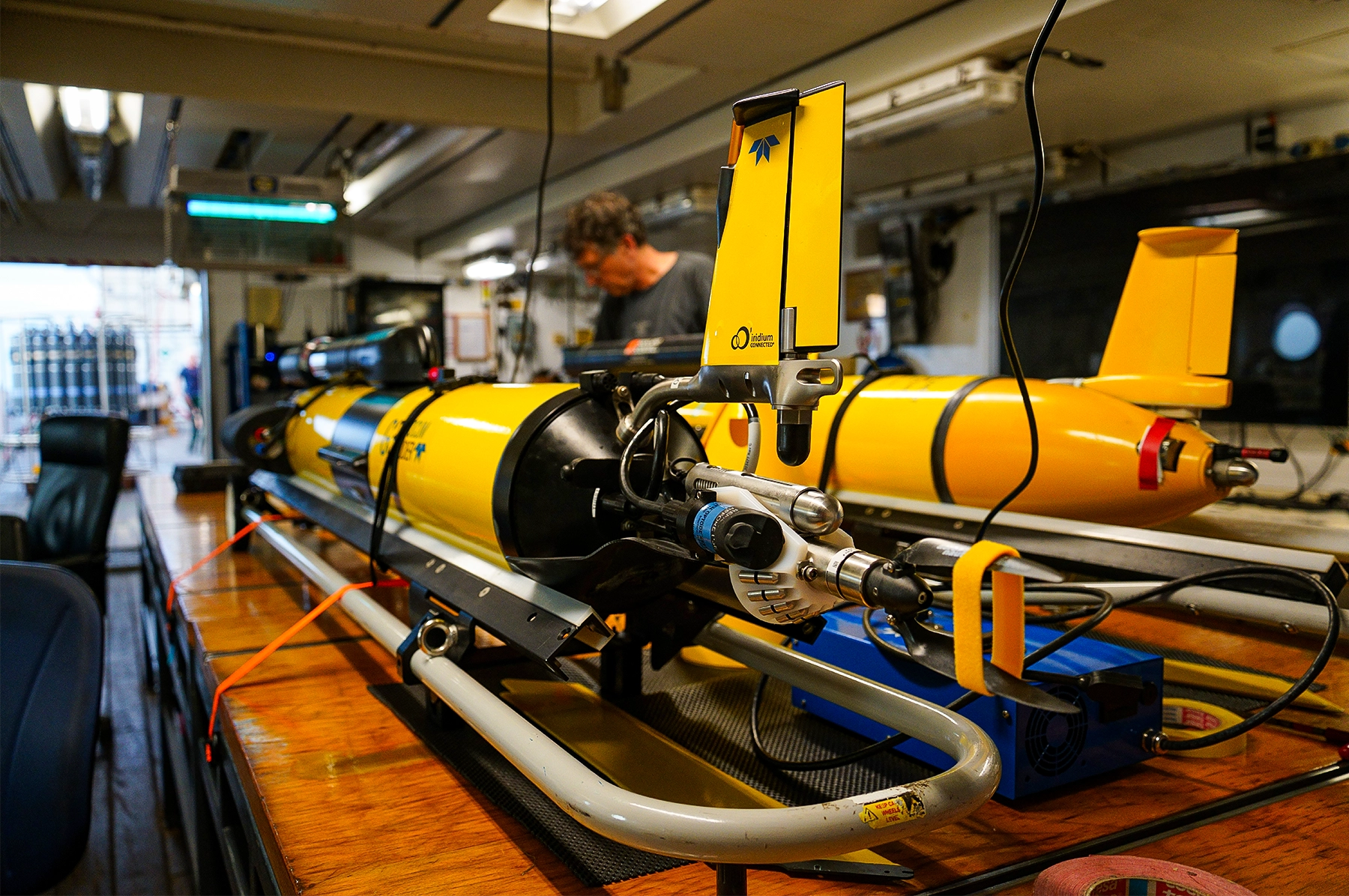 Two yellow gliders are housed inside a boat.