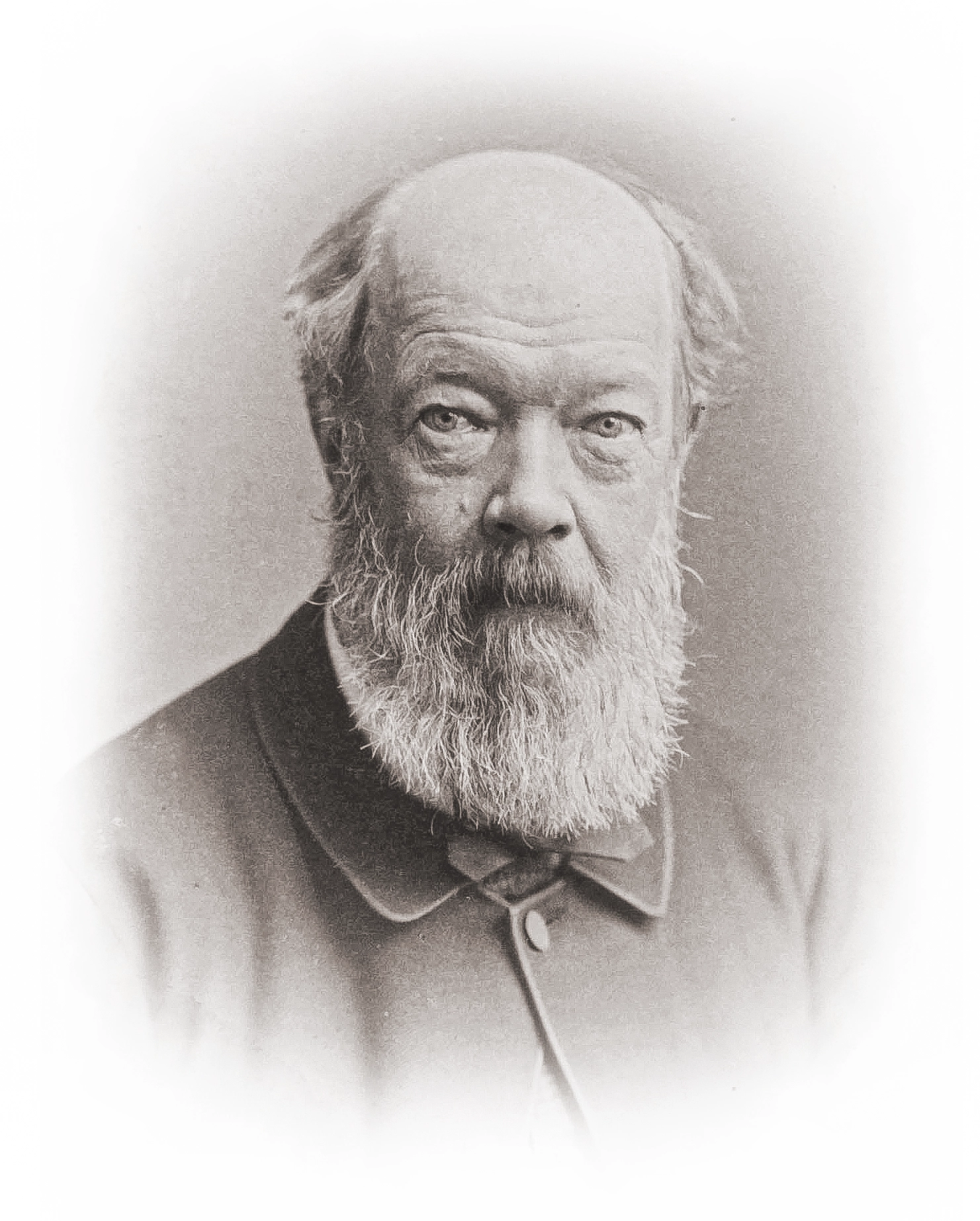 Black-and-white portrait of a bald man with a white beard.