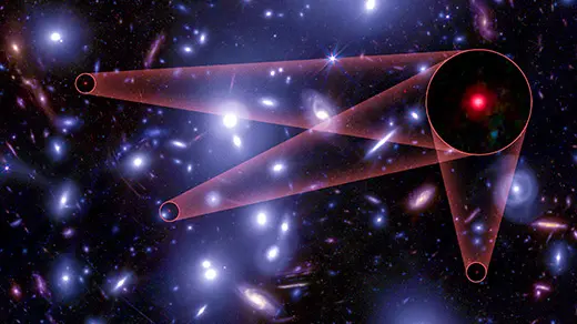 A field of large white galaxies hides three tiny red dots.