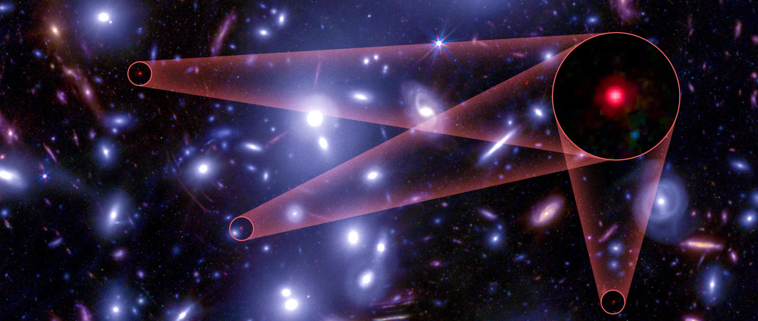 A field of large white galaxies hides three tiny red dots.