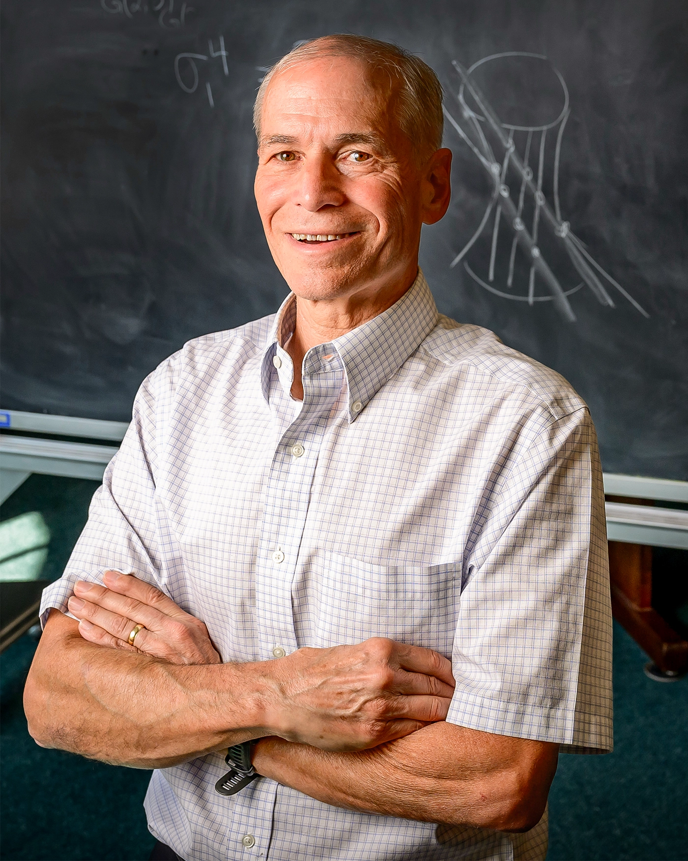 Man standing at a blackboard.