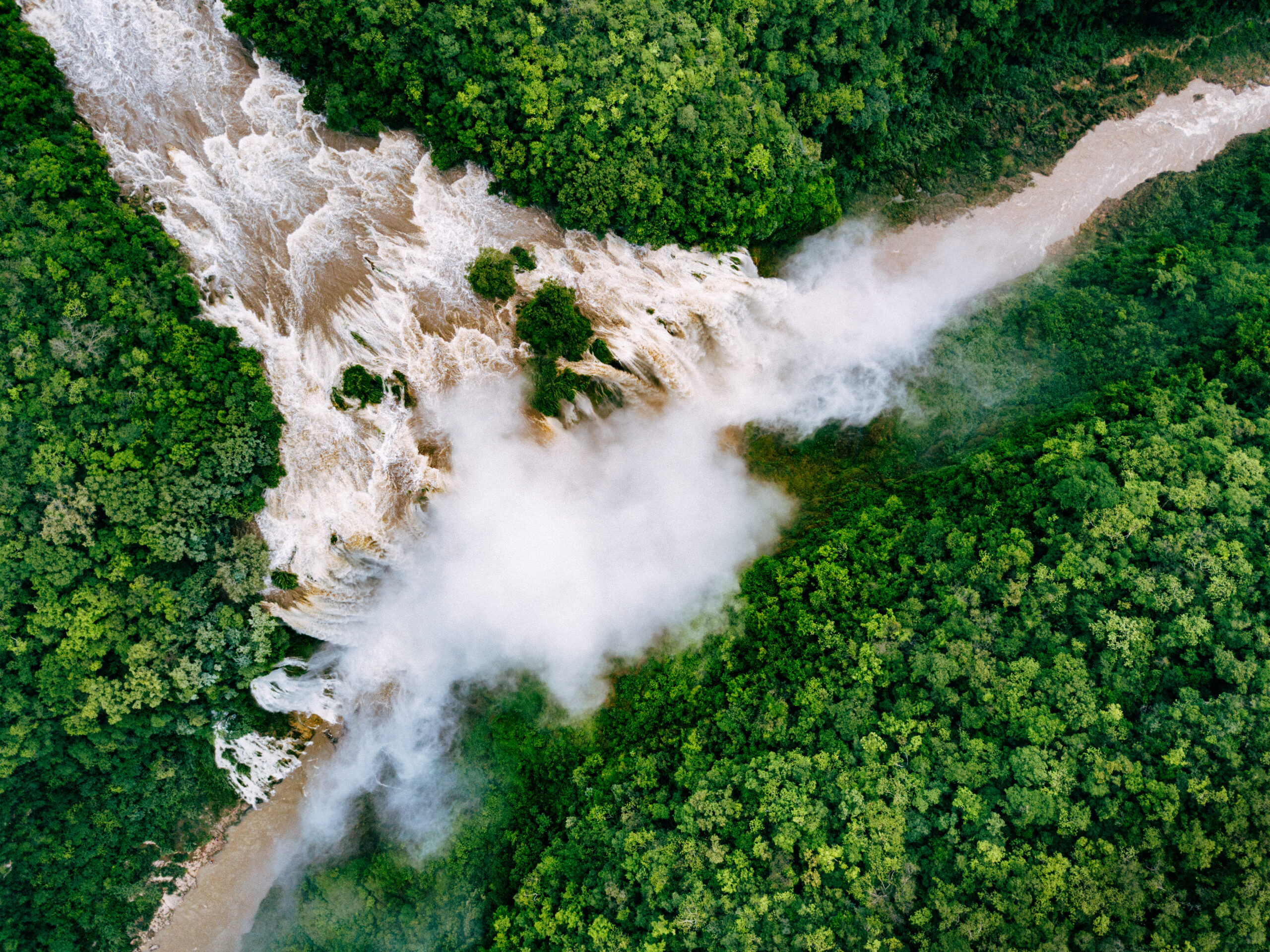 Aerial photo of a waterfall where one river joins another.