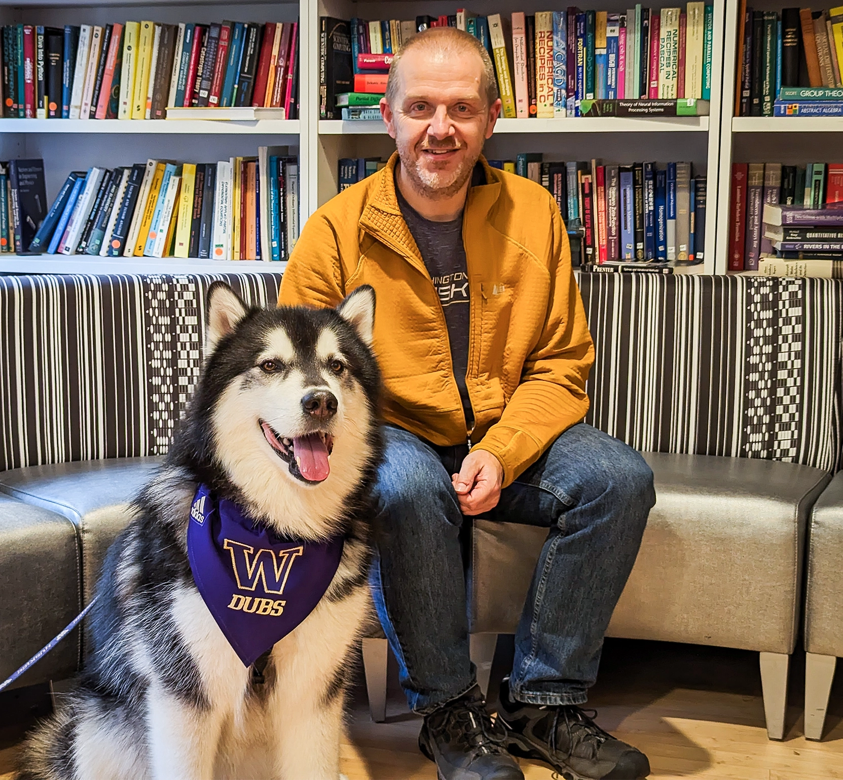 photo of a man in a yellow coat with his dog