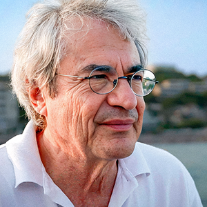 A man with glasses looking into the distance