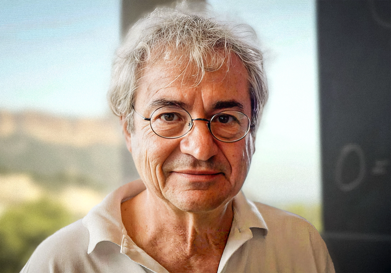 A man with glasses looking into the camera