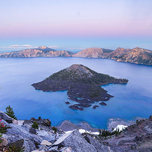 Bright blue water surrounds a volcanic island.