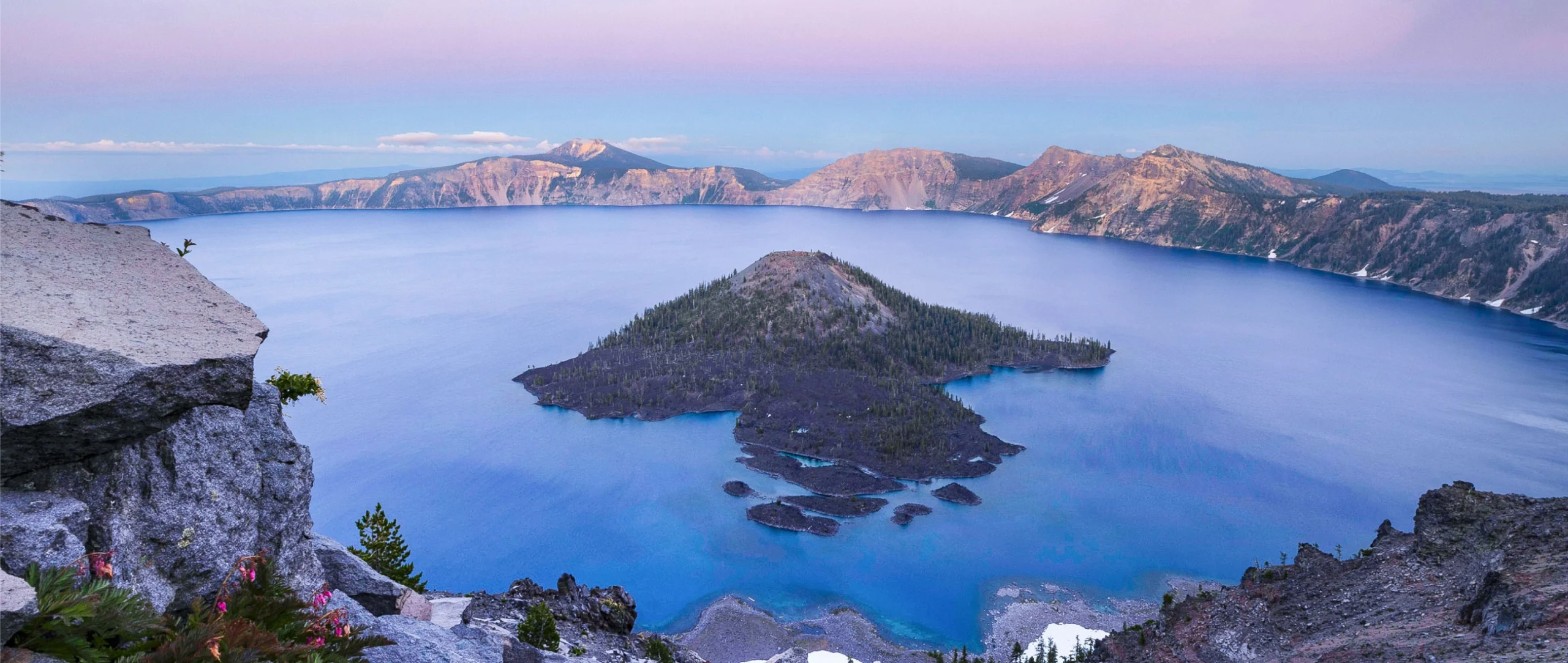 Bright blue water surrounds a volcanic island.