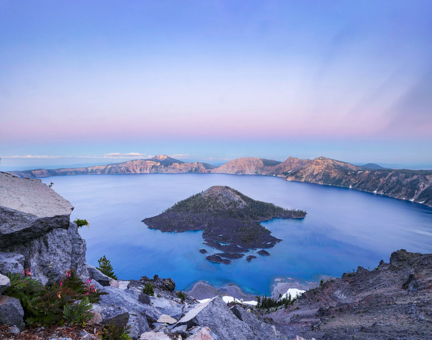 Bright blue water surrounds a volcanic island.
