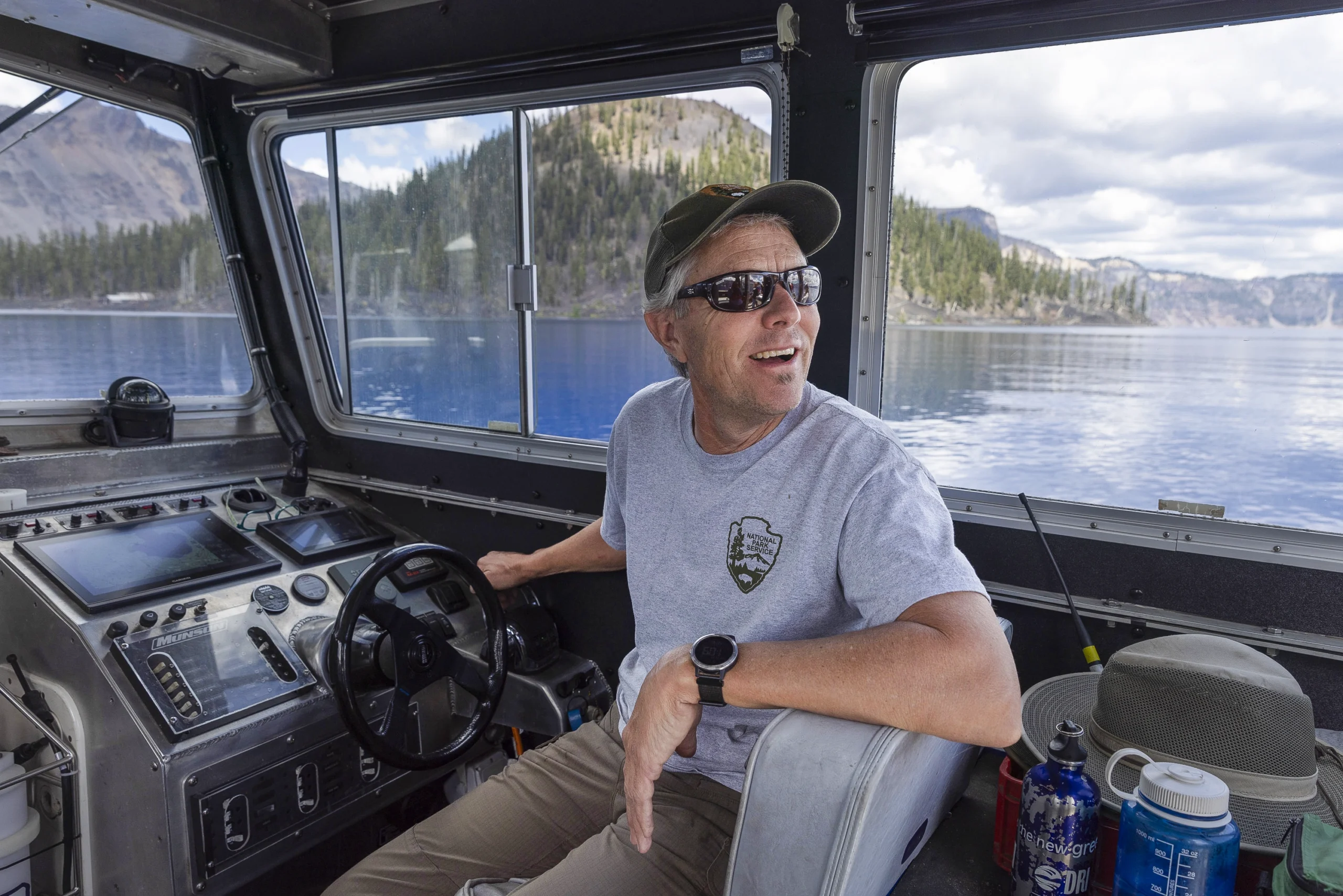Scott Girdner smiles while he drives a research boat on Crater Lake.