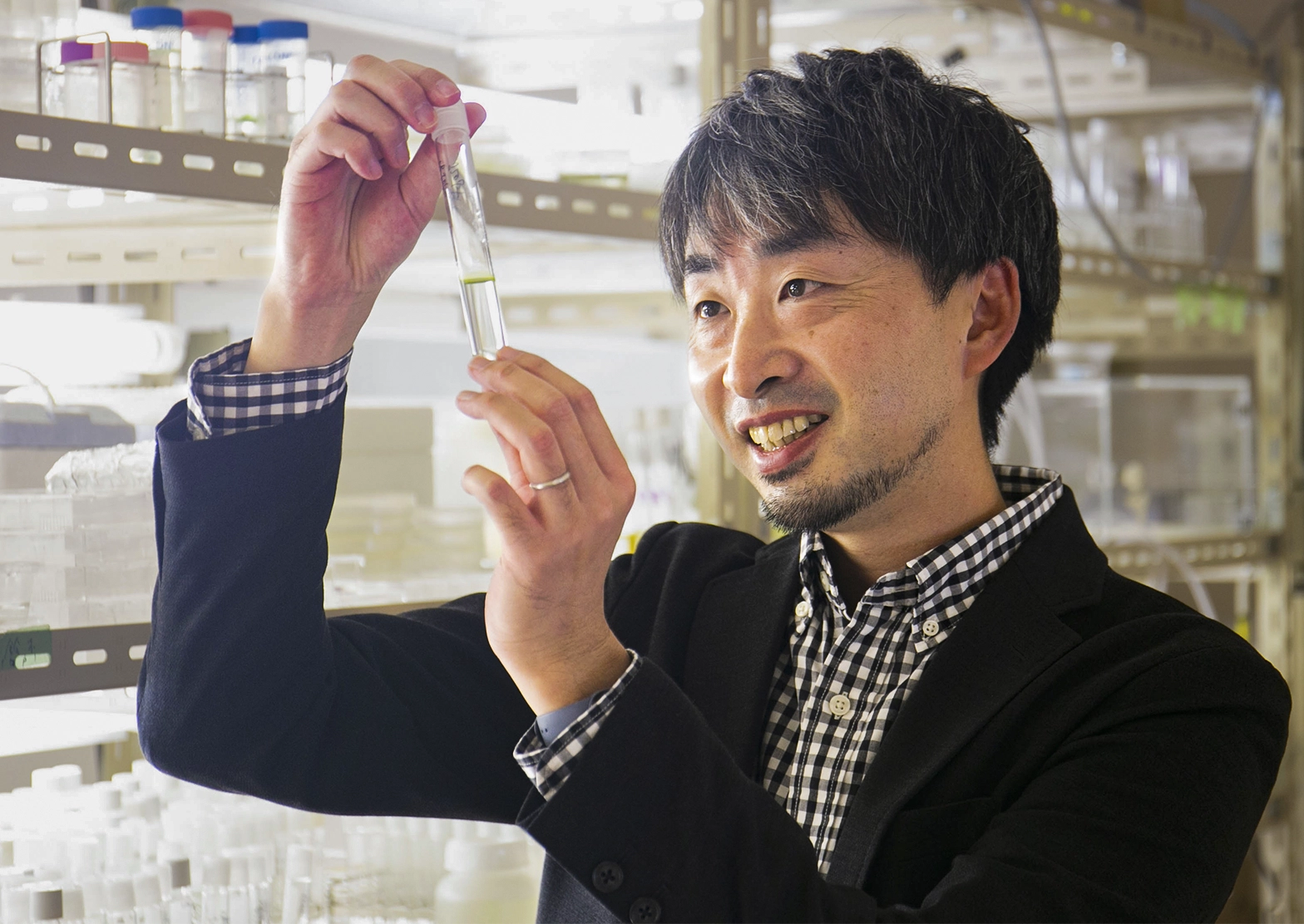 Takuro Nakayama holds a test tube.