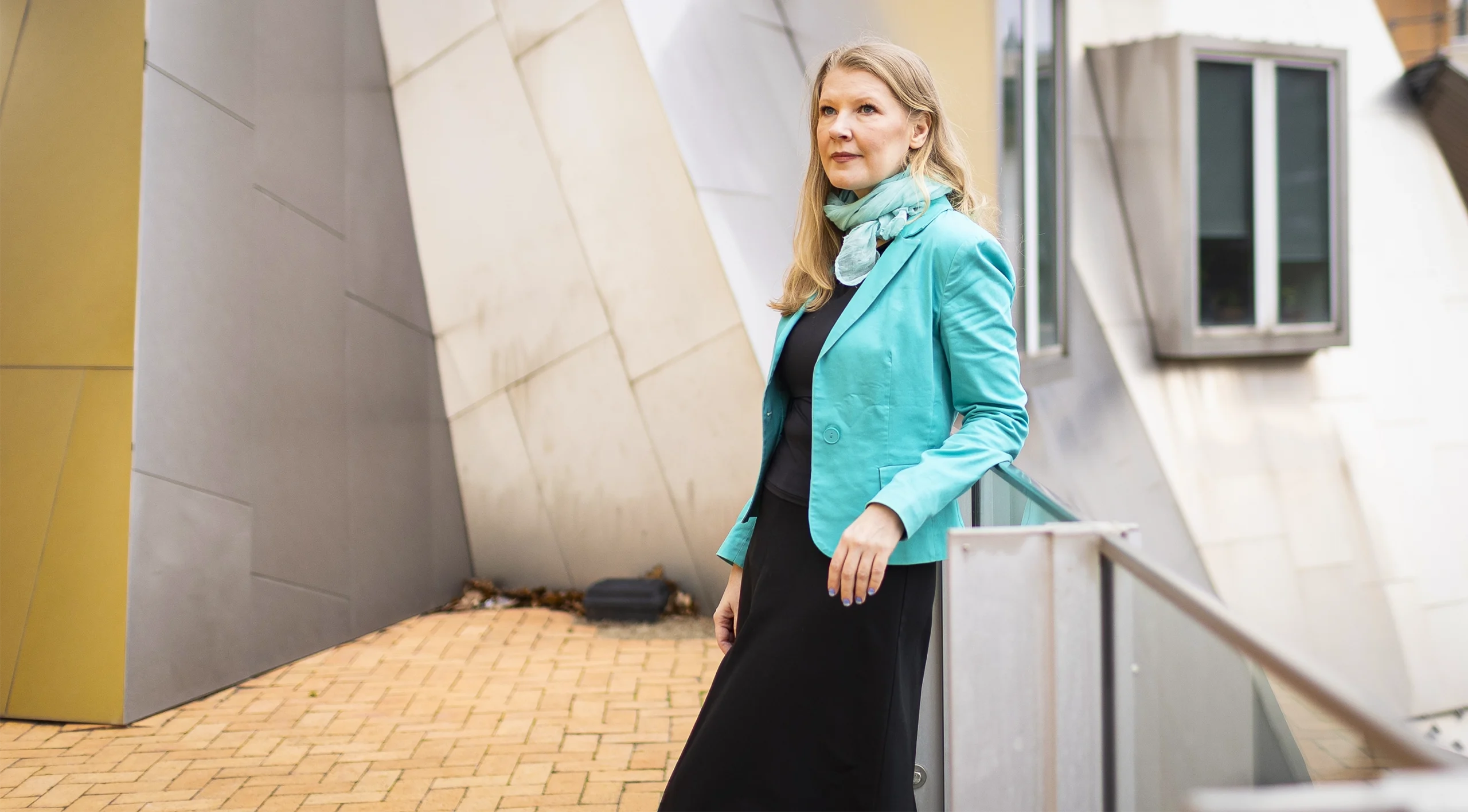 Fedorenko leans against a railing on MIT’s campus.
