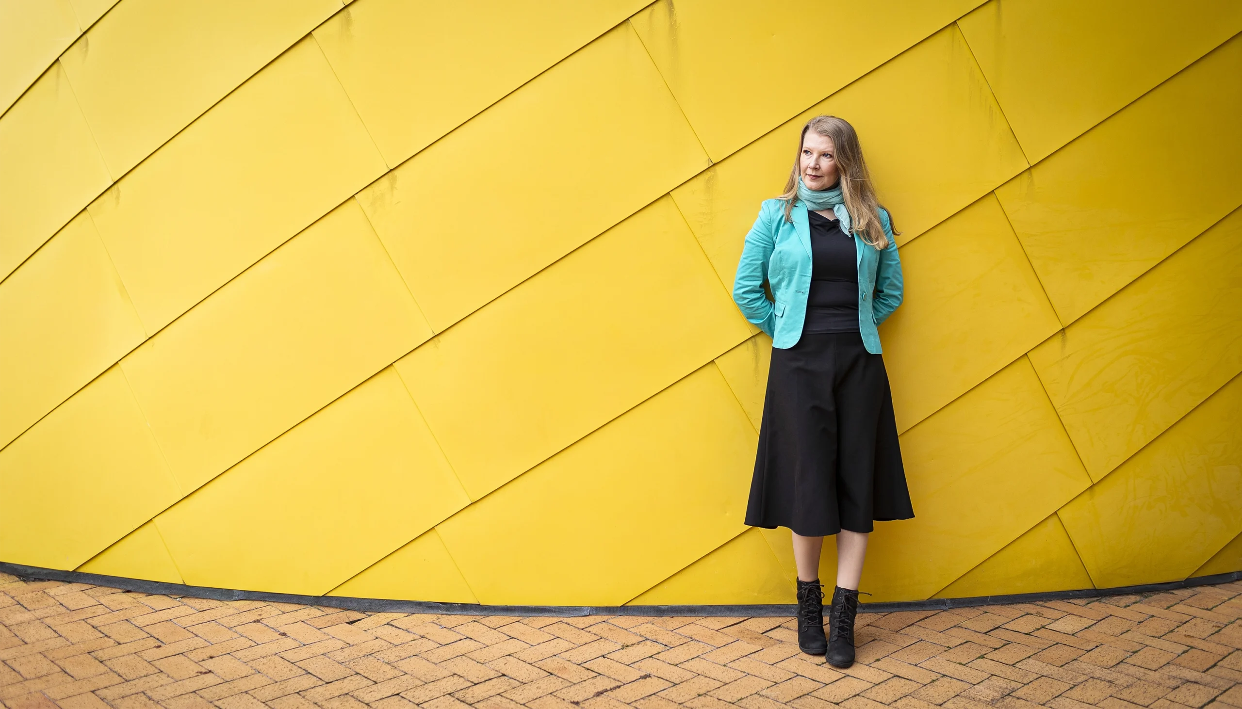Fedorenko leans against a yellow wall.