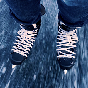A close-up video of ice skates skating on ice.