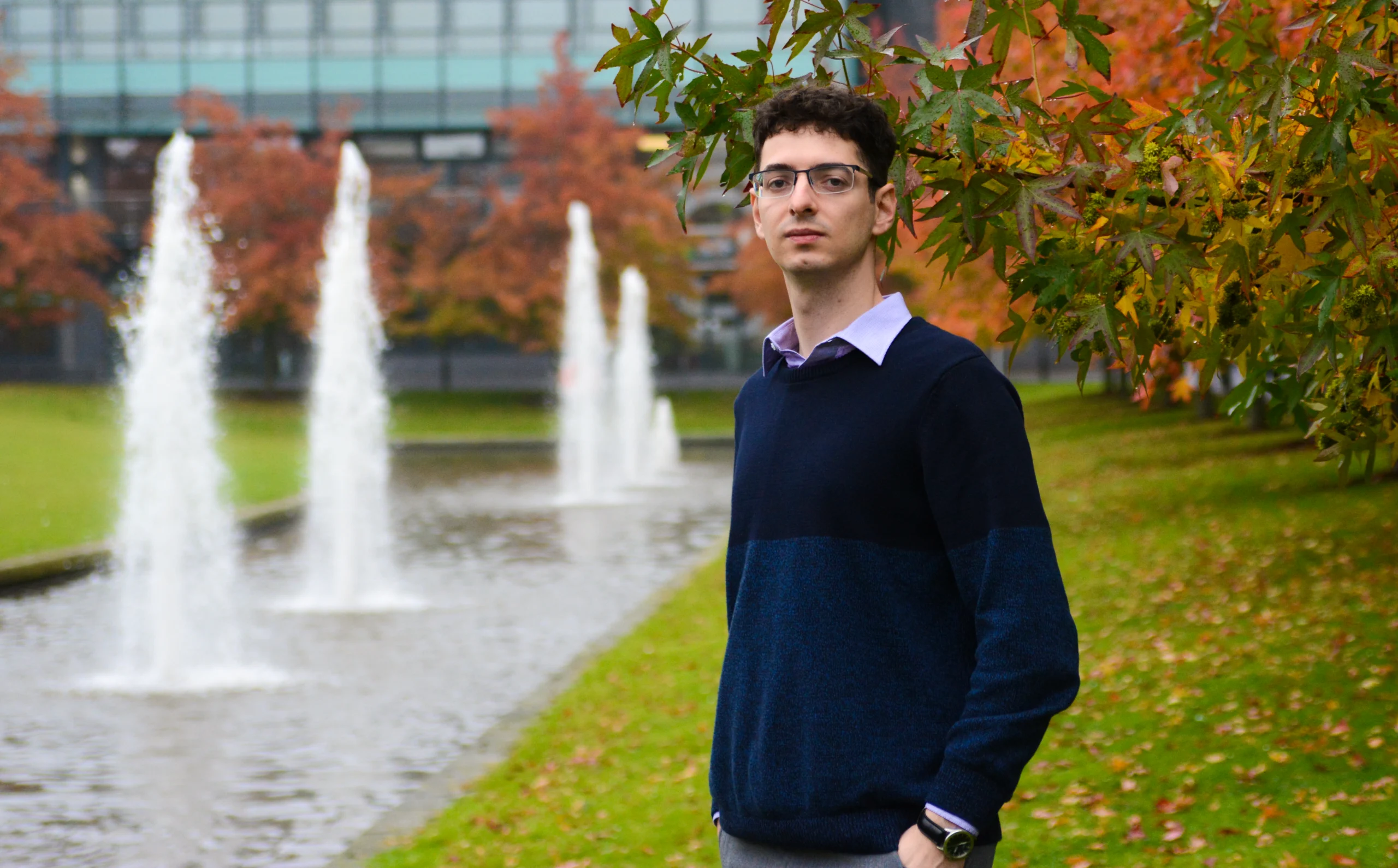 A man next to fountains.