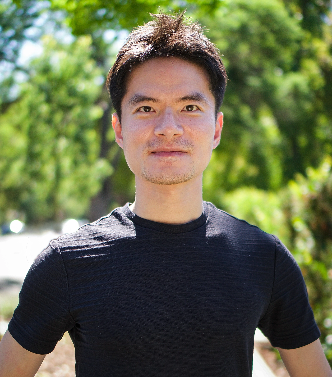 Man standing with his hands on his waist.