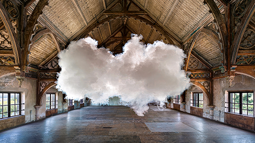 In a photograph staged by artist Berndnaut Smilde, a small cloud hovers inside a room.