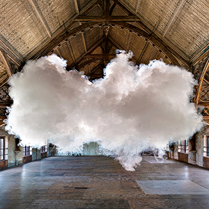 In a photograph staged by artist Berndnaut Smilde, a small cloud hovers inside a room.