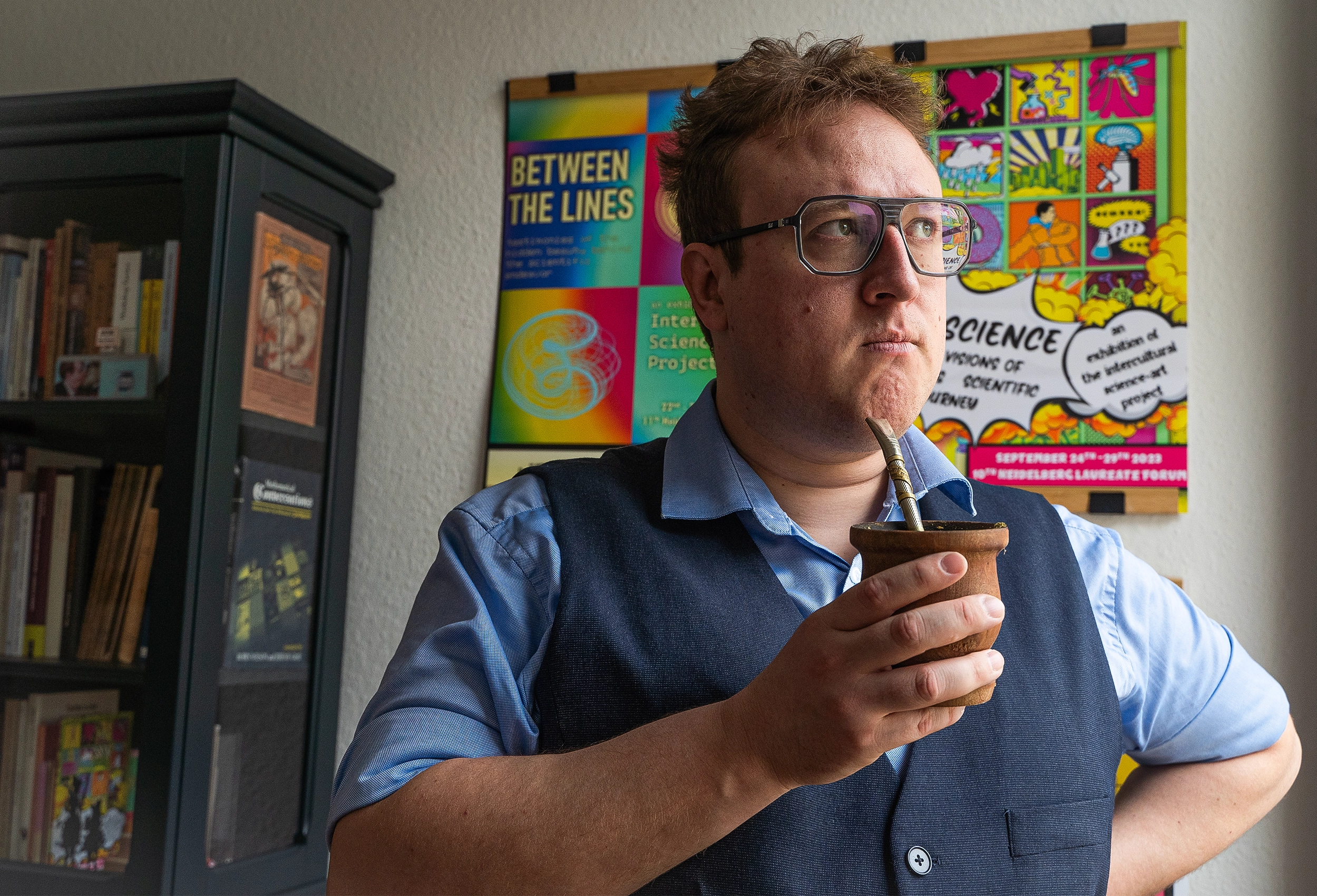 Man in glasses drinking maté.