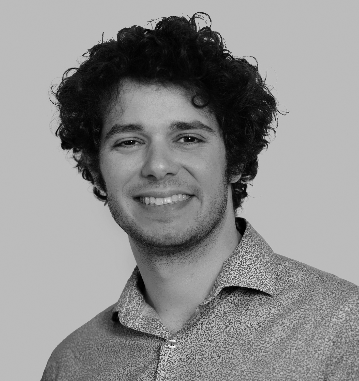 A smiling man in a button down shirt