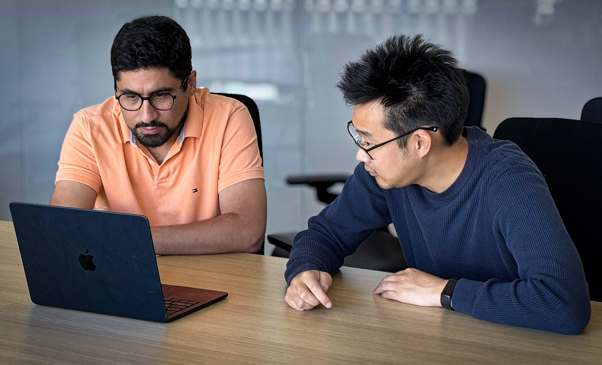Reza Abbasi-Asl and Alex Lee work at a laptop.