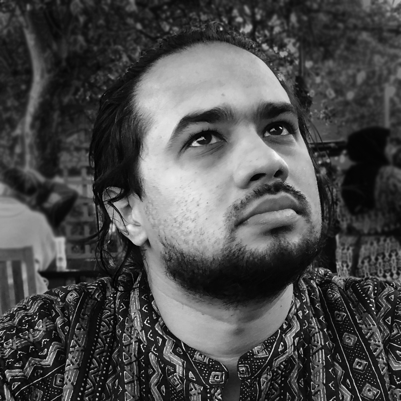 A black and white photo of a bearded man