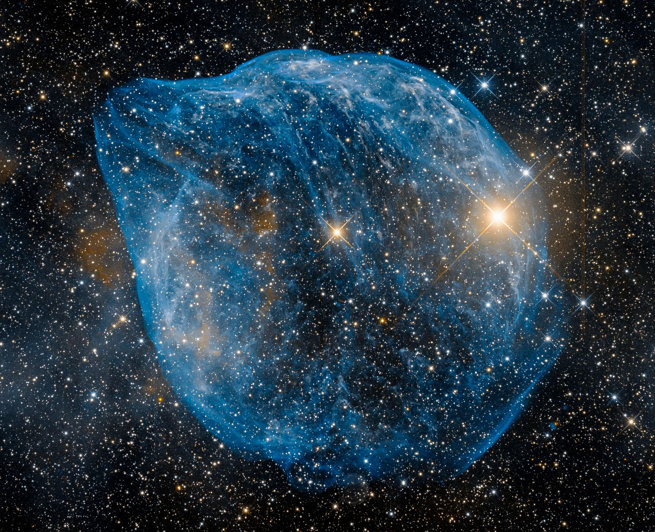 An image in space shows an irregular bubble with a blue hue on a background of stars. A protrusion on the bubble causes it to resemble the head of a dolphin.