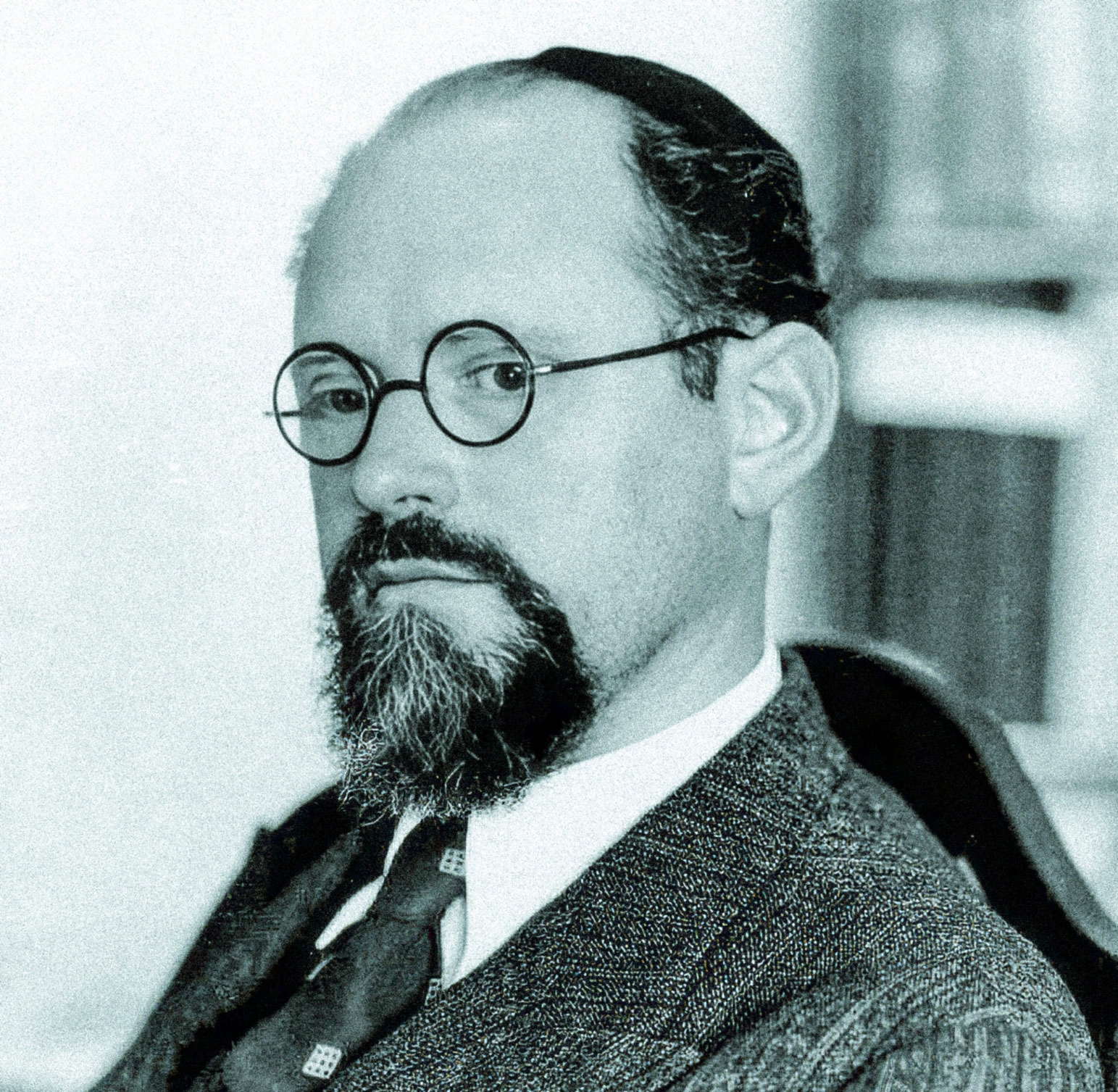 Black-and-white photo of a man wearing a suit.