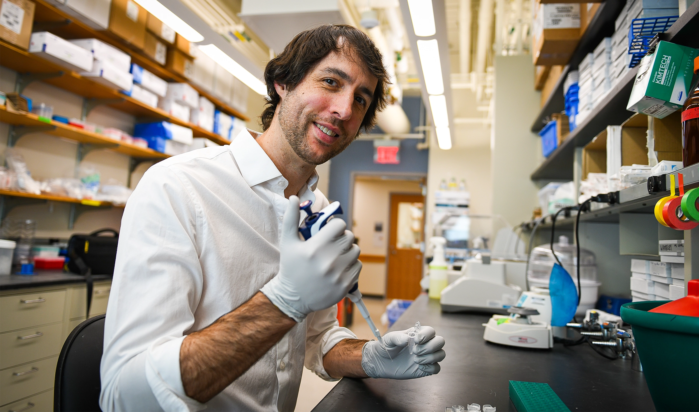 Philip Kranzusch holds a pipette at a lab bench.