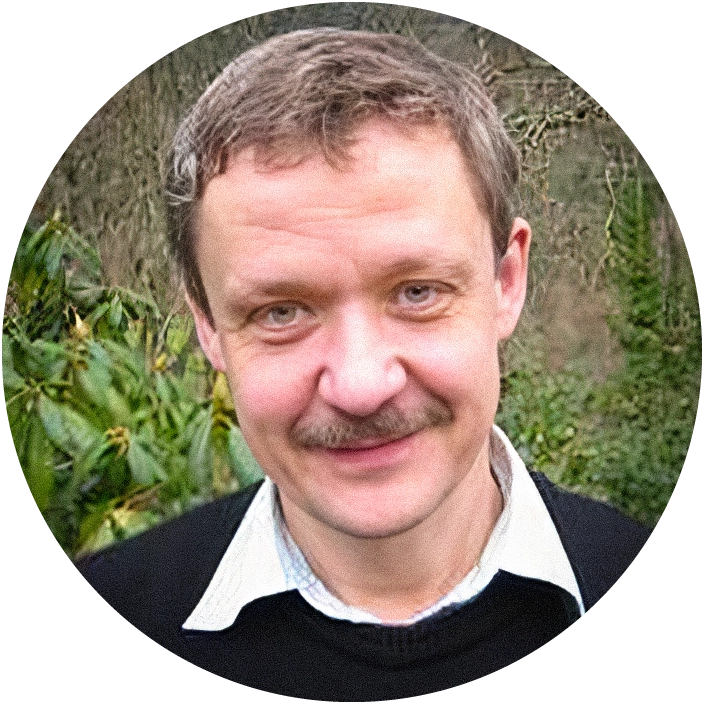 Man smiling outdoors.