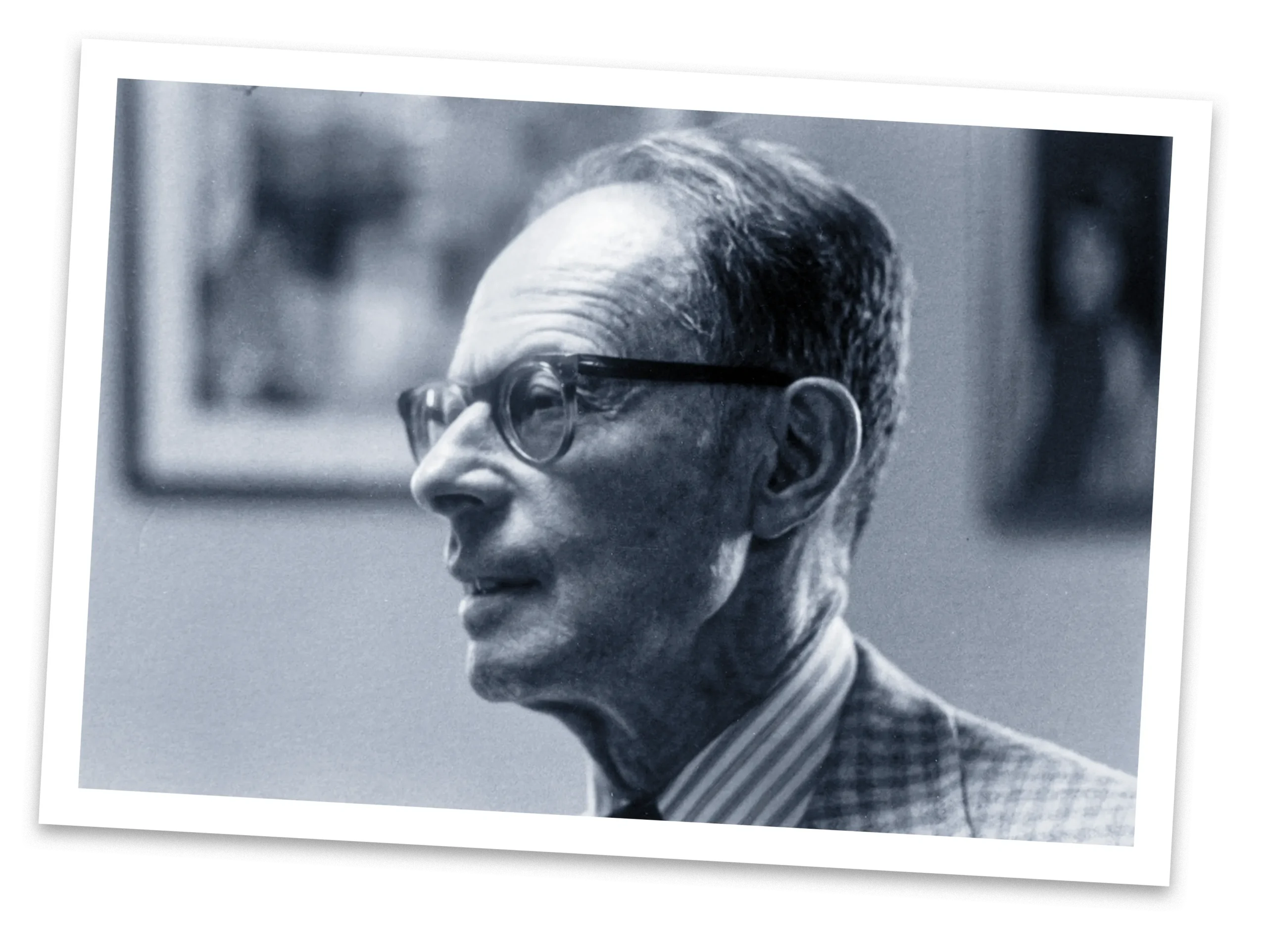 Black-and-white photo of a man with dark hair and glasses.